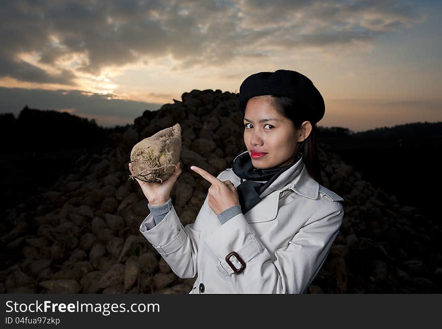 Pretty woman with sugar beet in her hand. Pretty woman with sugar beet in her hand