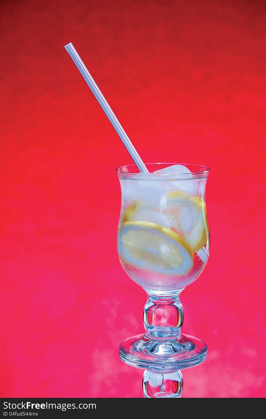 Cold fresh with ice lemonade  on  red background. Cold fresh with ice lemonade  on  red background