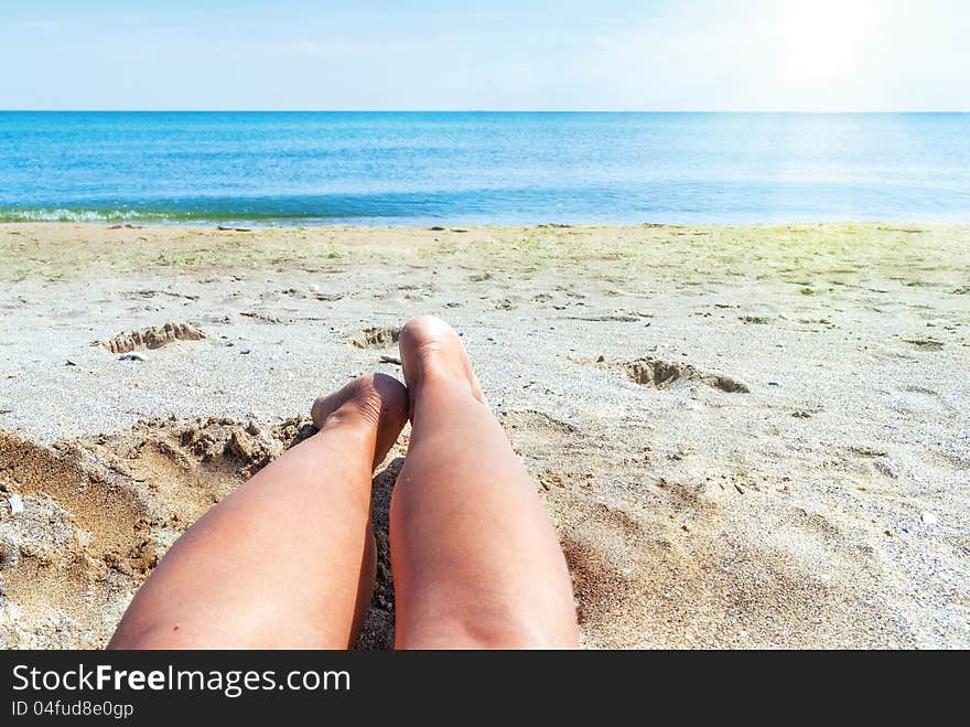 Wet female feet on the beach , sand and sun. Wet female feet on the beach , sand and sun