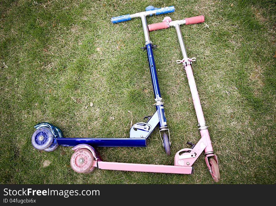 Tow scooters lying on the grass