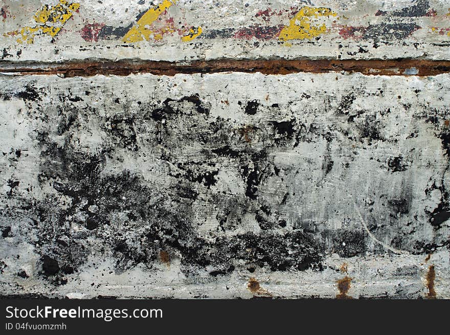 A grungy section of concrete from part of an old bunker with warning stripes. A grungy section of concrete from part of an old bunker with warning stripes.