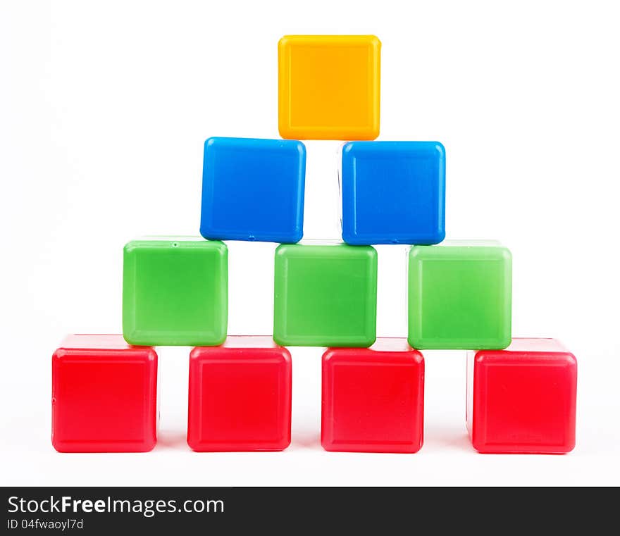 Pyramid made of toy construction brick blocks  on white. Pyramid made of toy construction brick blocks  on white