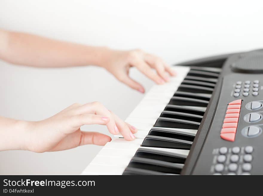 Hands of girl playing on electronic piano. Hands of girl playing on electronic piano