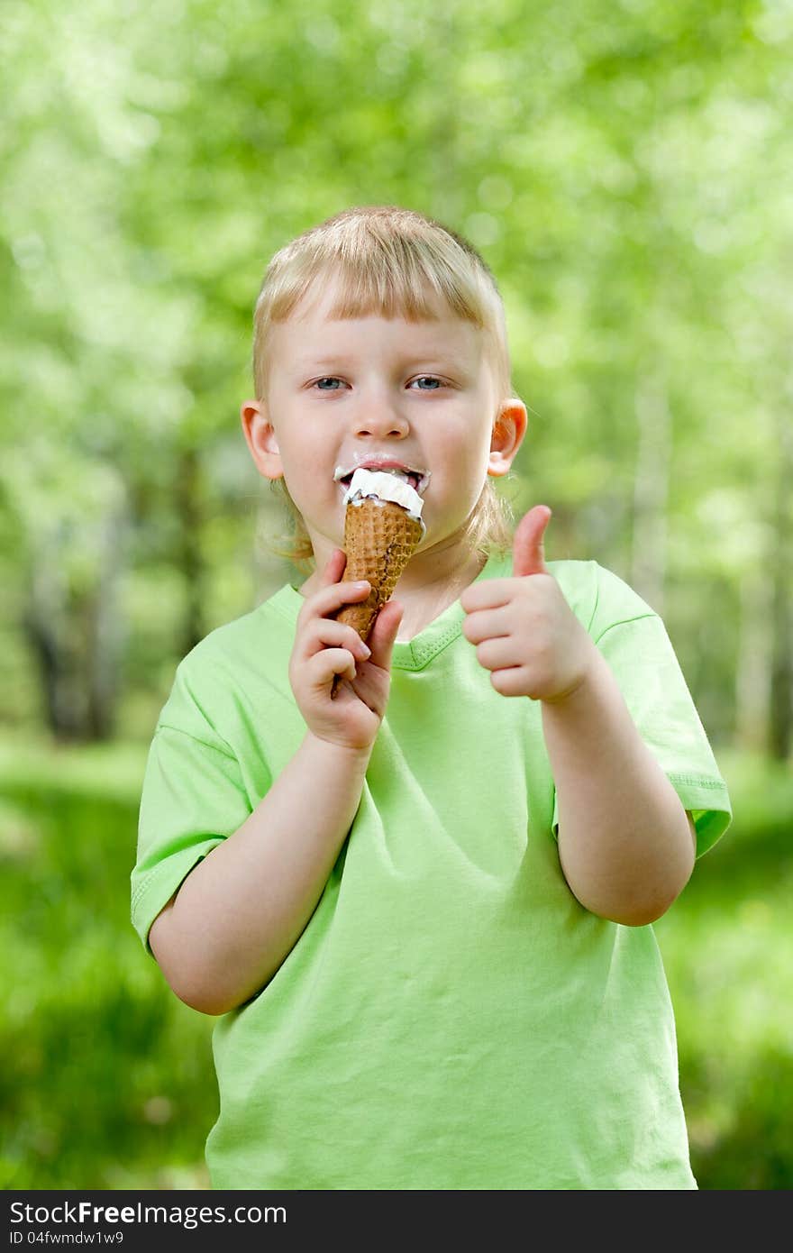 Kid Eating A Tasty Ice-cream Outdoor With Thumb Up