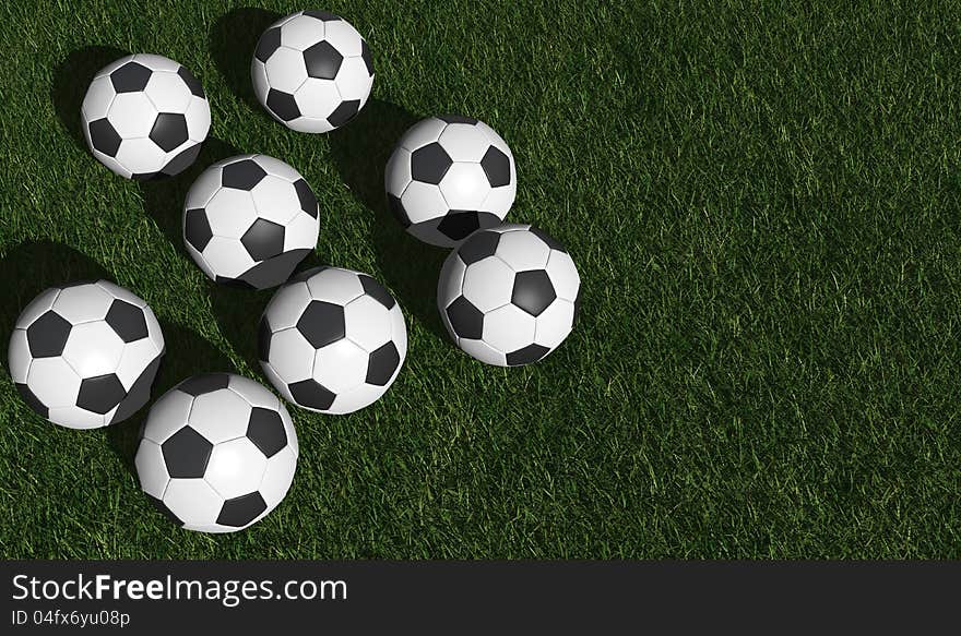 Soccer balls on a green grass