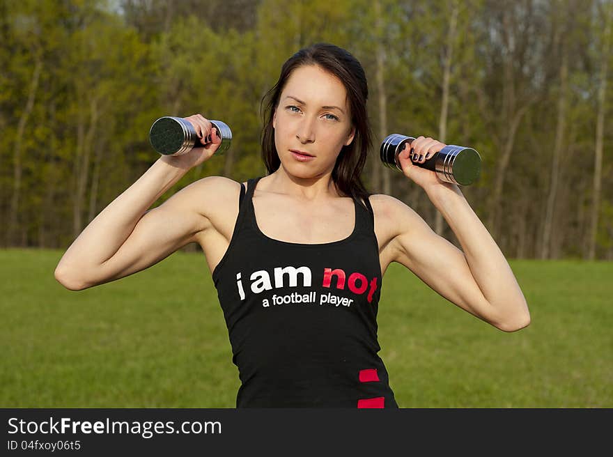 Woman working with dumbbell, sport theme shot