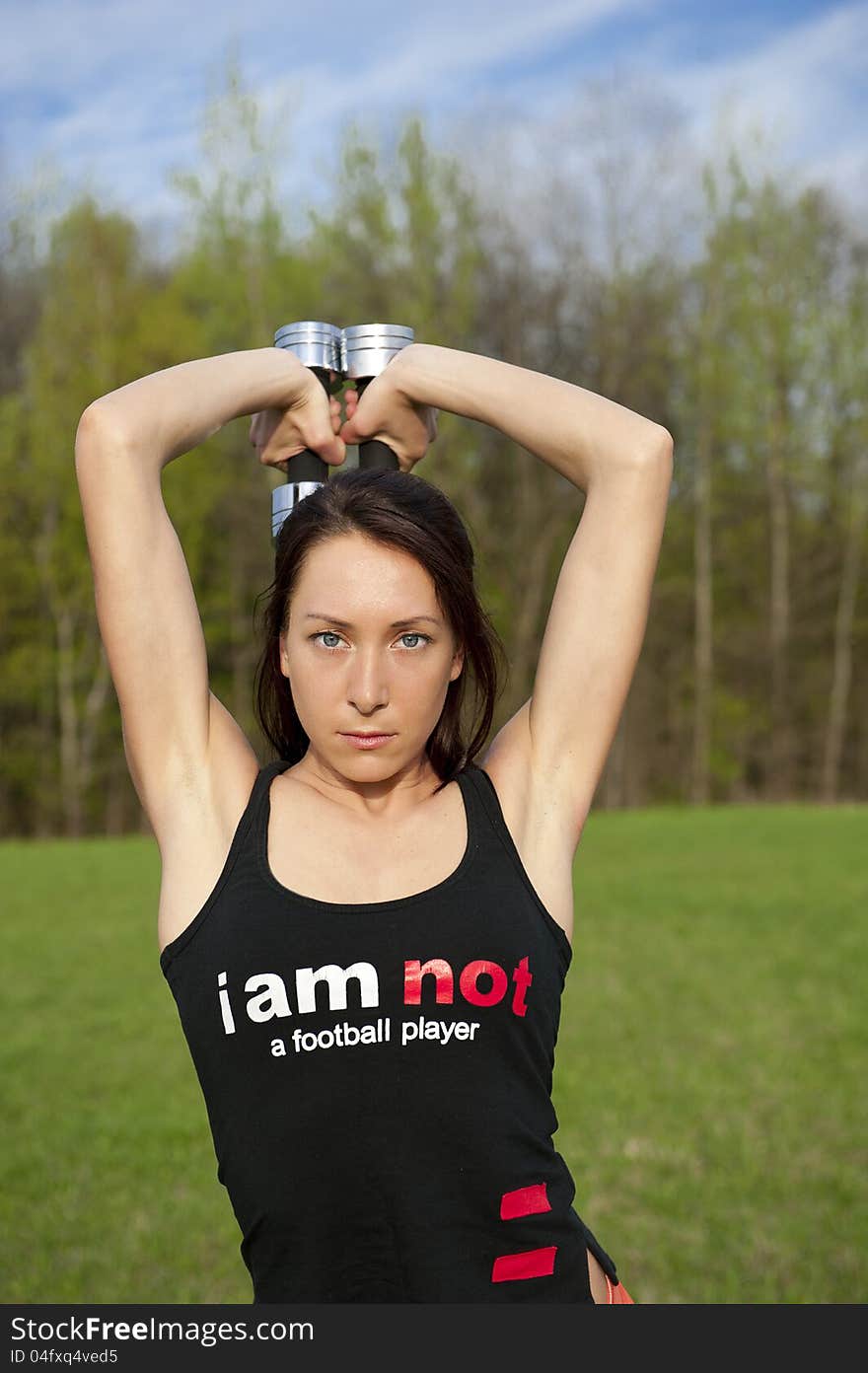 Woman working with dumbbell, sport theme shot