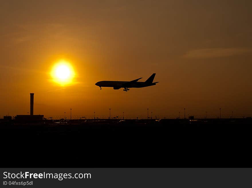 Airplane landing in sunset sky. Airplane landing in sunset sky