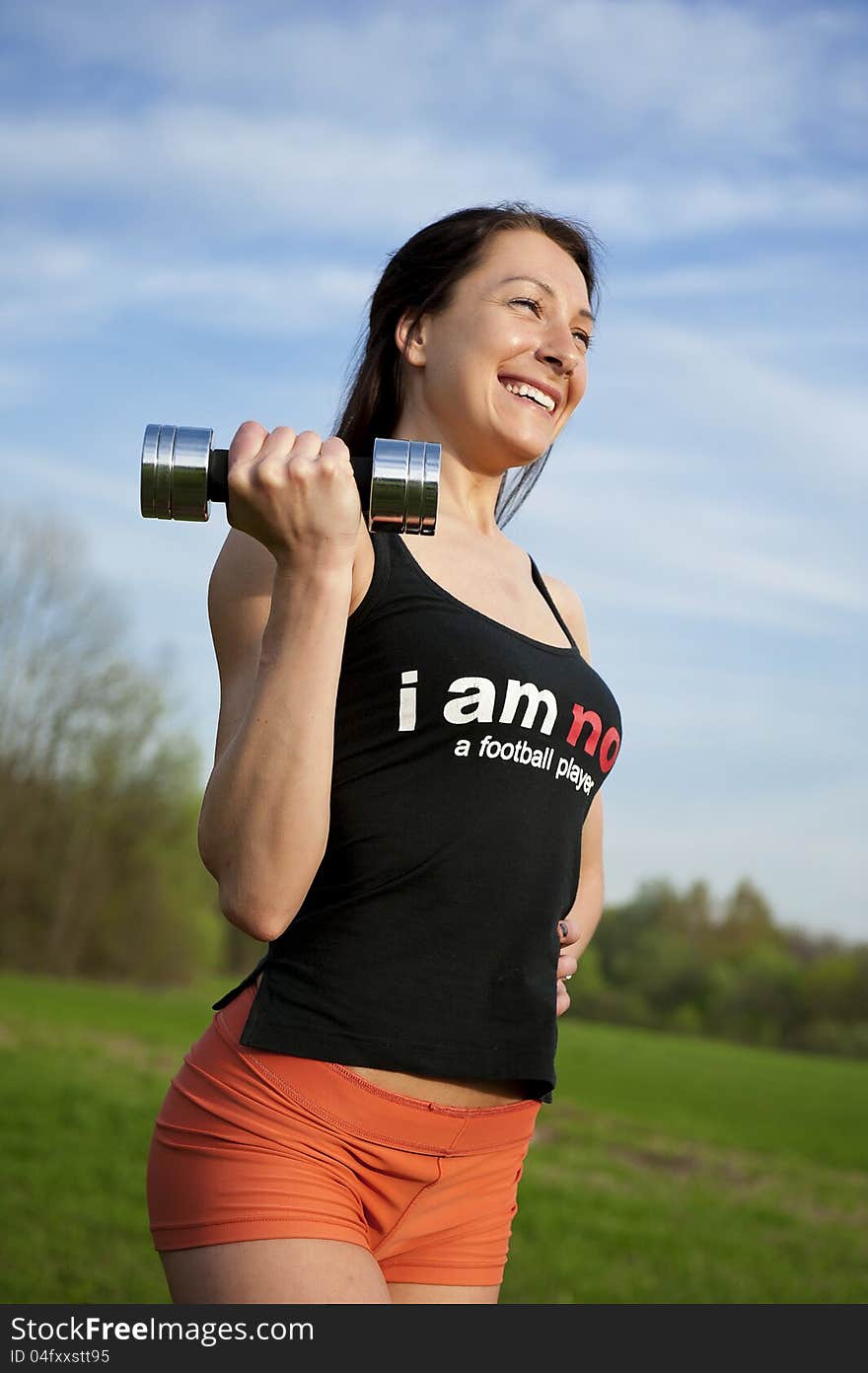 Woman working with dumbbell, sport theme shot