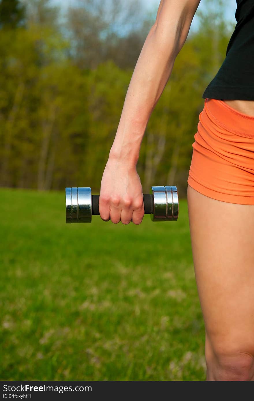 Woman working with dumbbell, sport theme shot