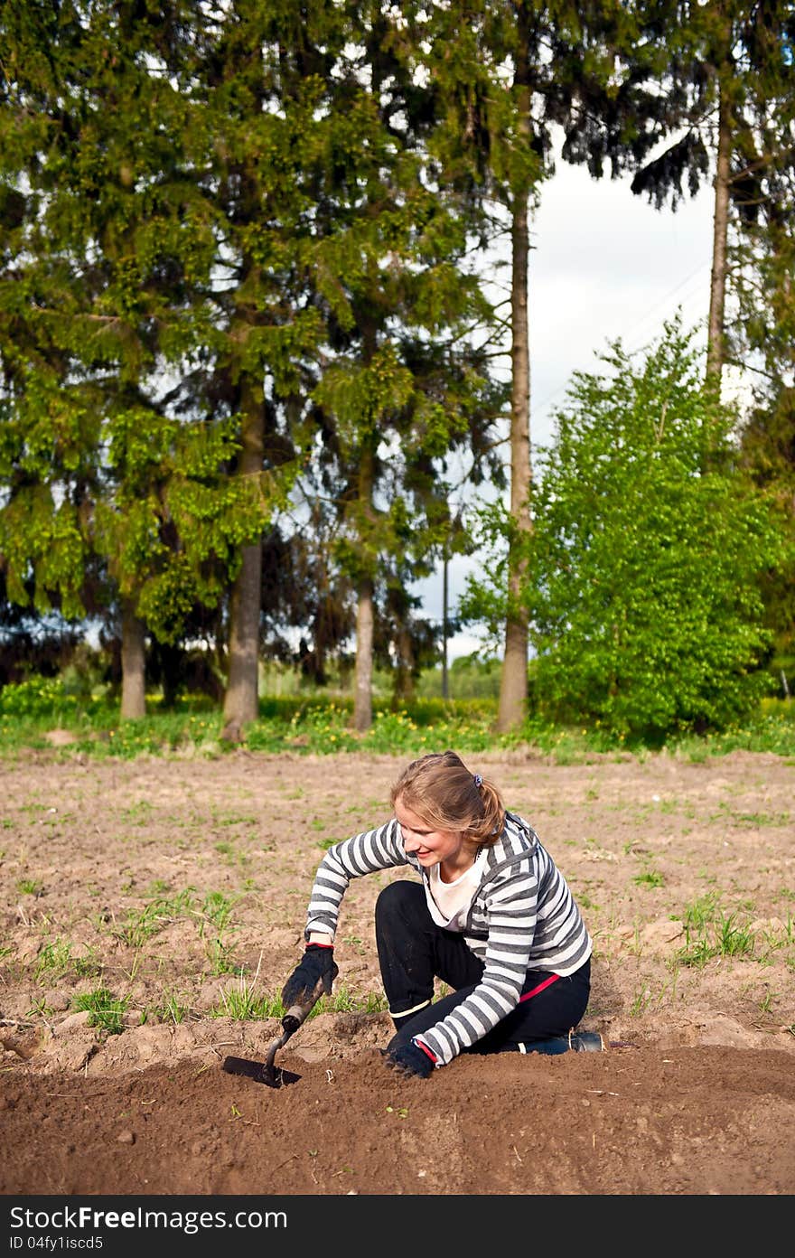 Young woman weeding tillage