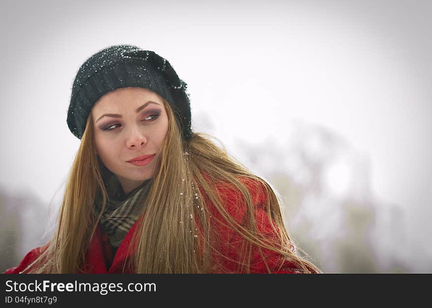 Happy Girl With Cap And Gloves Playing With Snow