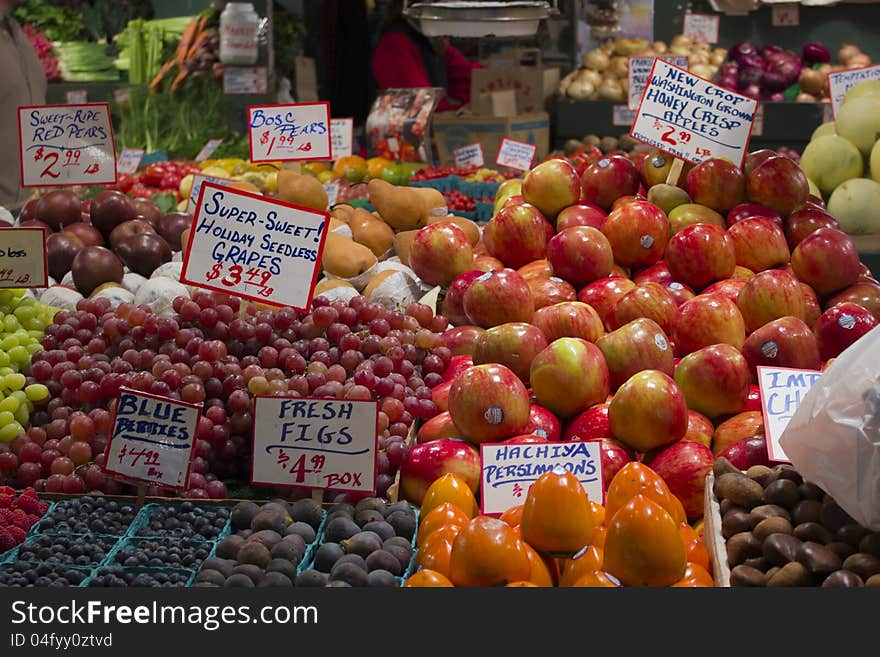 Fresh washington apples, red grapes, green grapes, red pears, blue berries, figs, persimmons, and melons. Fresh washington apples, red grapes, green grapes, red pears, blue berries, figs, persimmons, and melons.