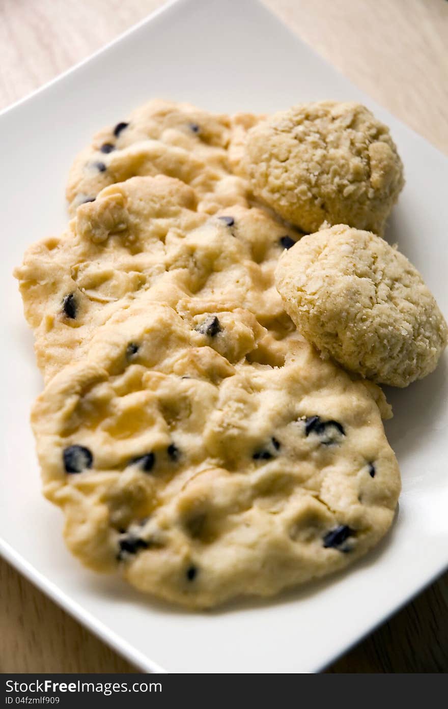 Many kinds of homemade cookies on white plate