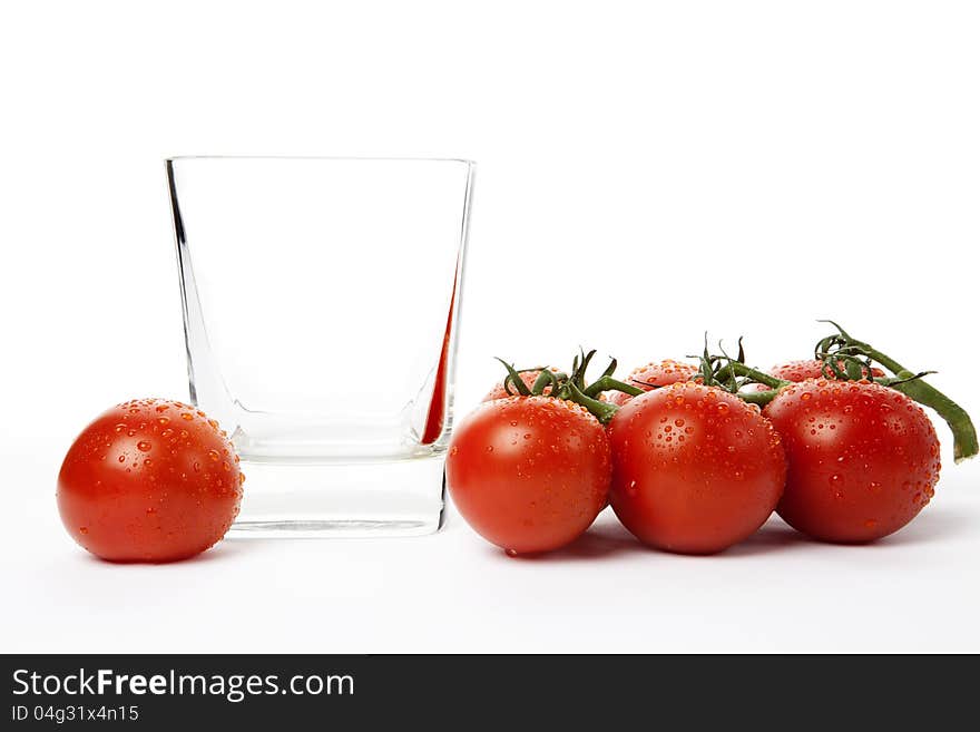 Fresh cherry tomatoes in a glass, isolated on white background