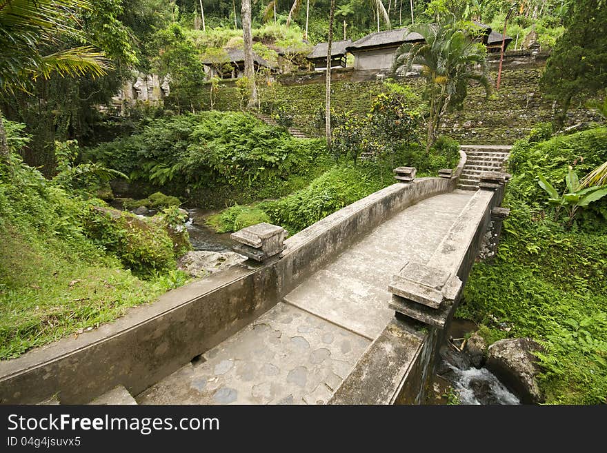 Old stone bridge at Gunung Kawis green and lush environment in Bali.