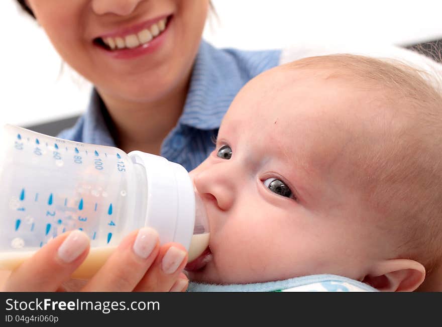 Adorable baby drinking a bottle - focus in the face