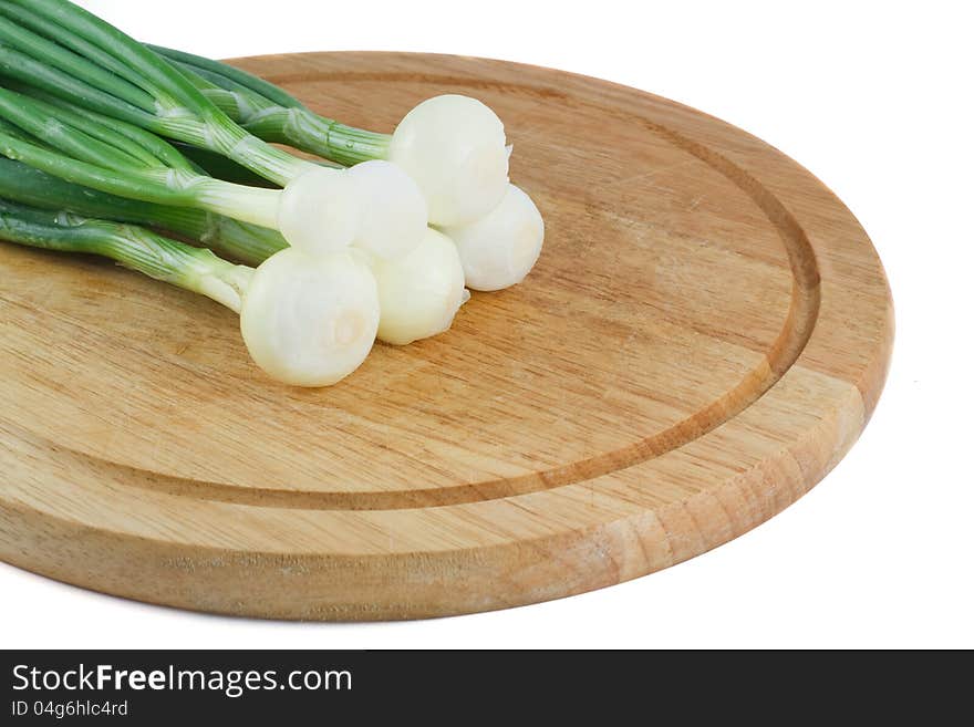 Green onions on a wooden  board