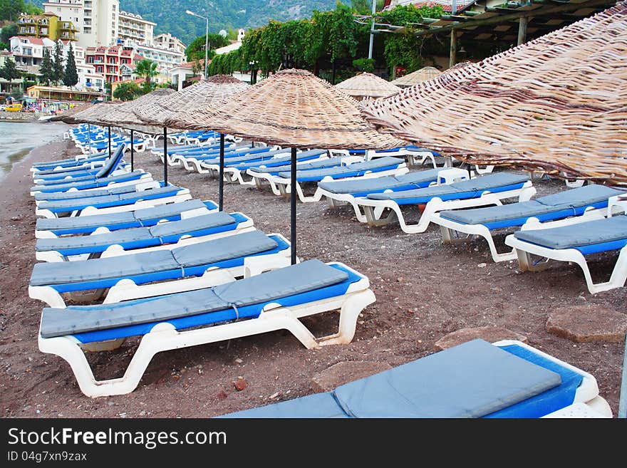 Rows of blue beach chairs on the shore. Rows of blue beach chairs on the shore