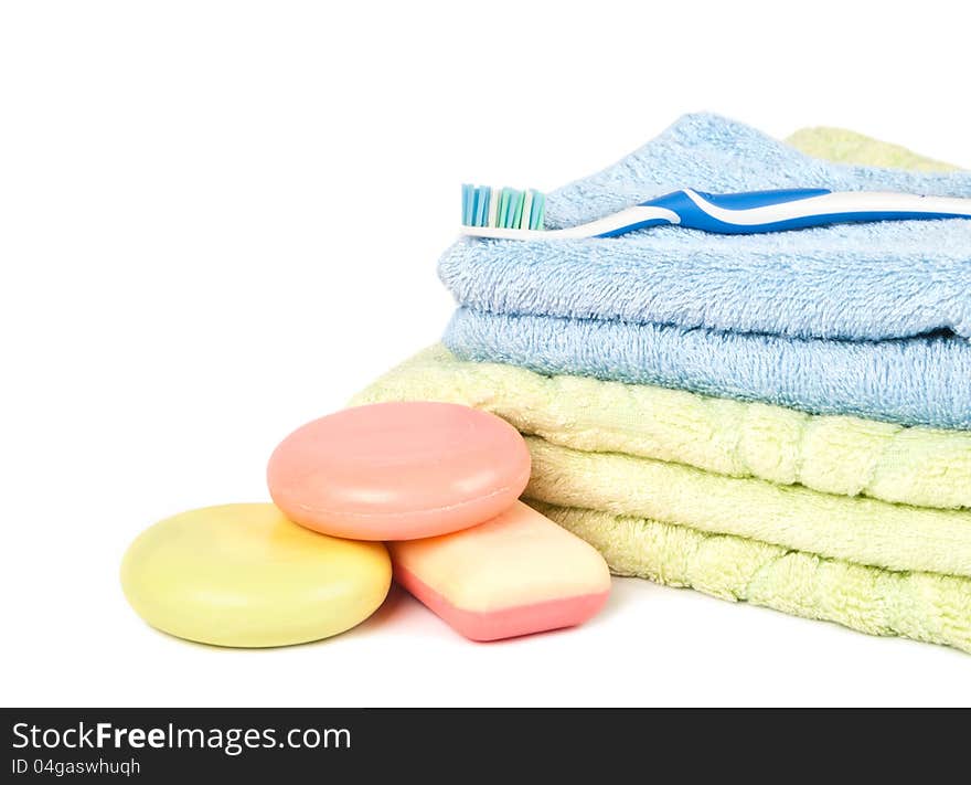 Soap lies a heap on a background towels by a pile and tooth brush. Soap lies a heap on a background towels by a pile and tooth brush