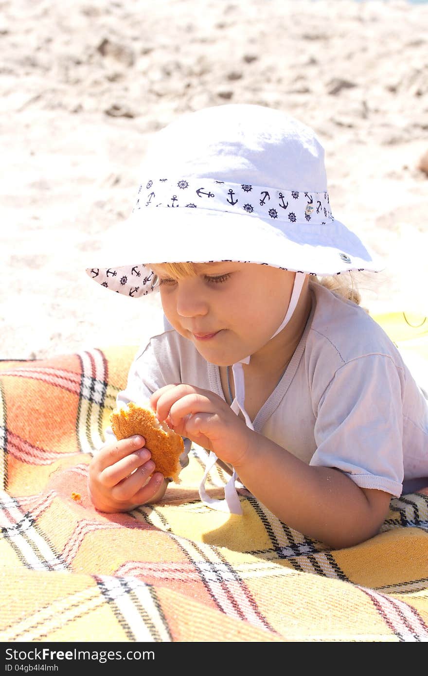 Beautiful little girl on the sand at the beach in summer. Beautiful little girl on the sand at the beach in summer