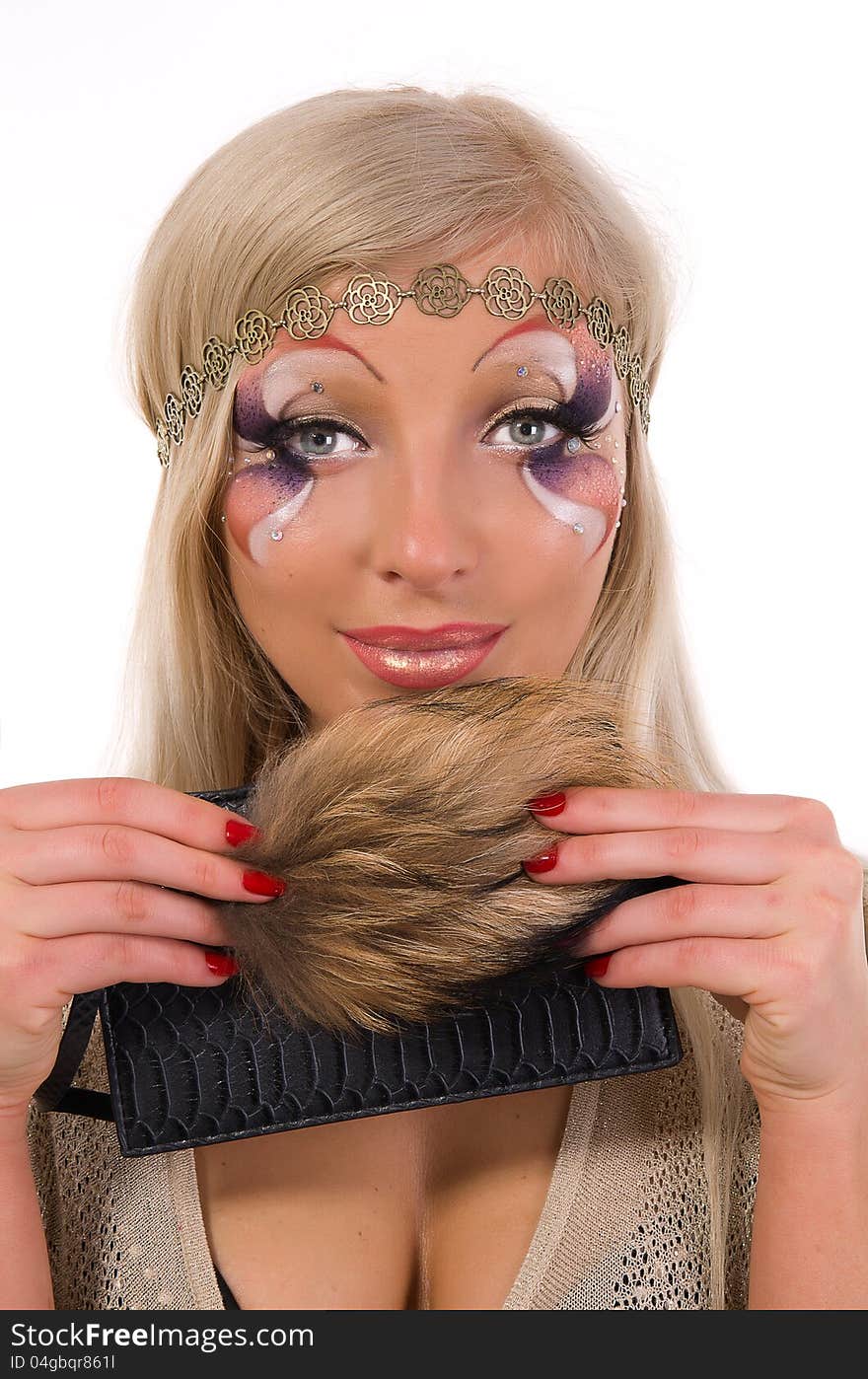 Beautiful girl with a Professional make-up with fur in his hands on a white background