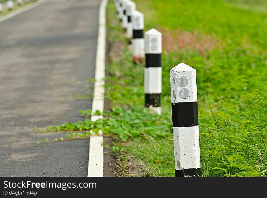 Road with black and white street sign. Road with black and white street sign