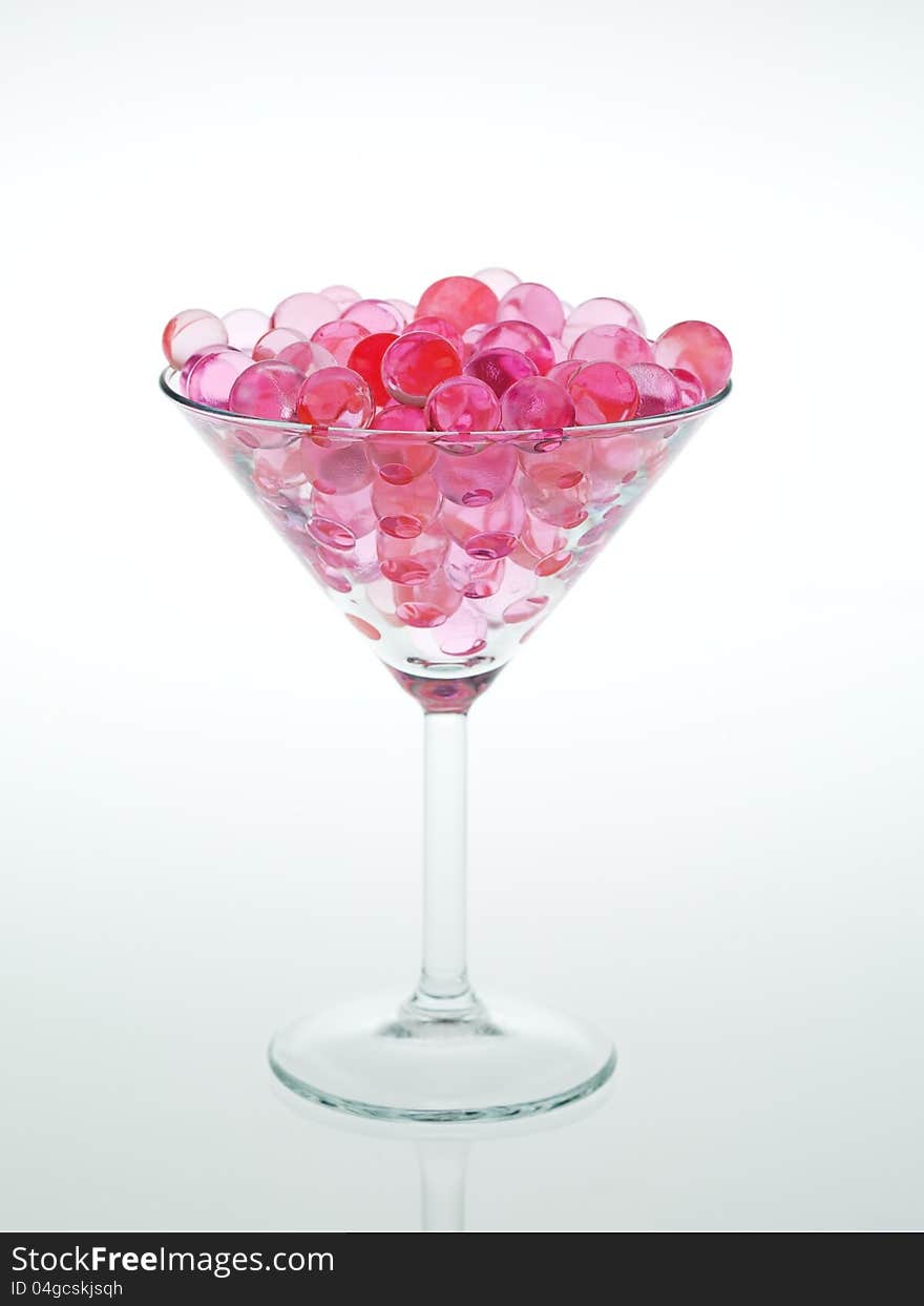 Transparent pink glass beads with white background