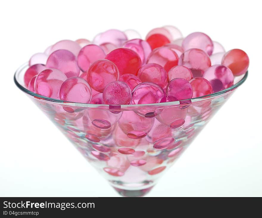 Transparent pink glass beads with white background