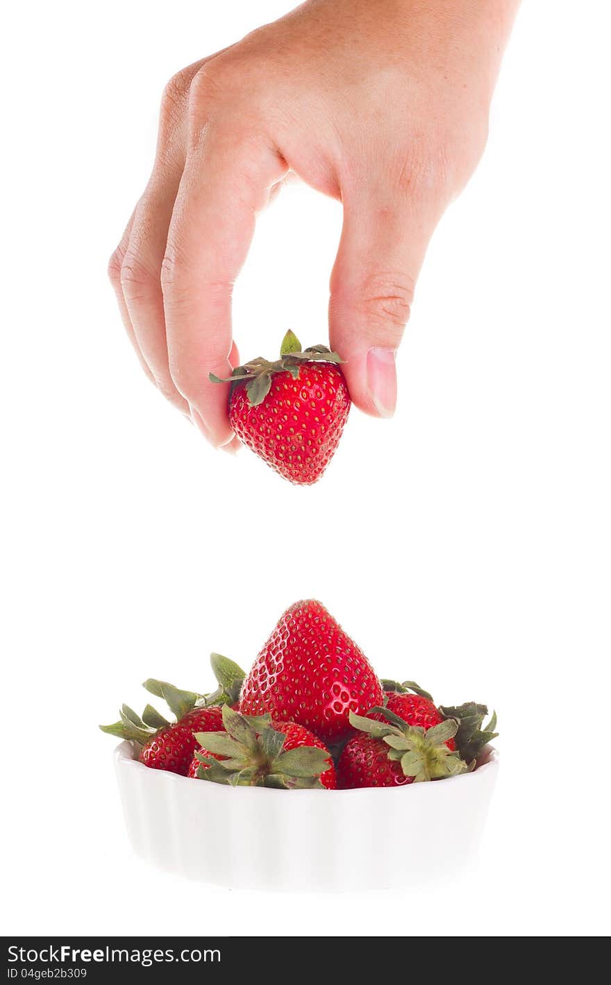 Hand taking strawberry out of bowl. Hand taking strawberry out of bowl