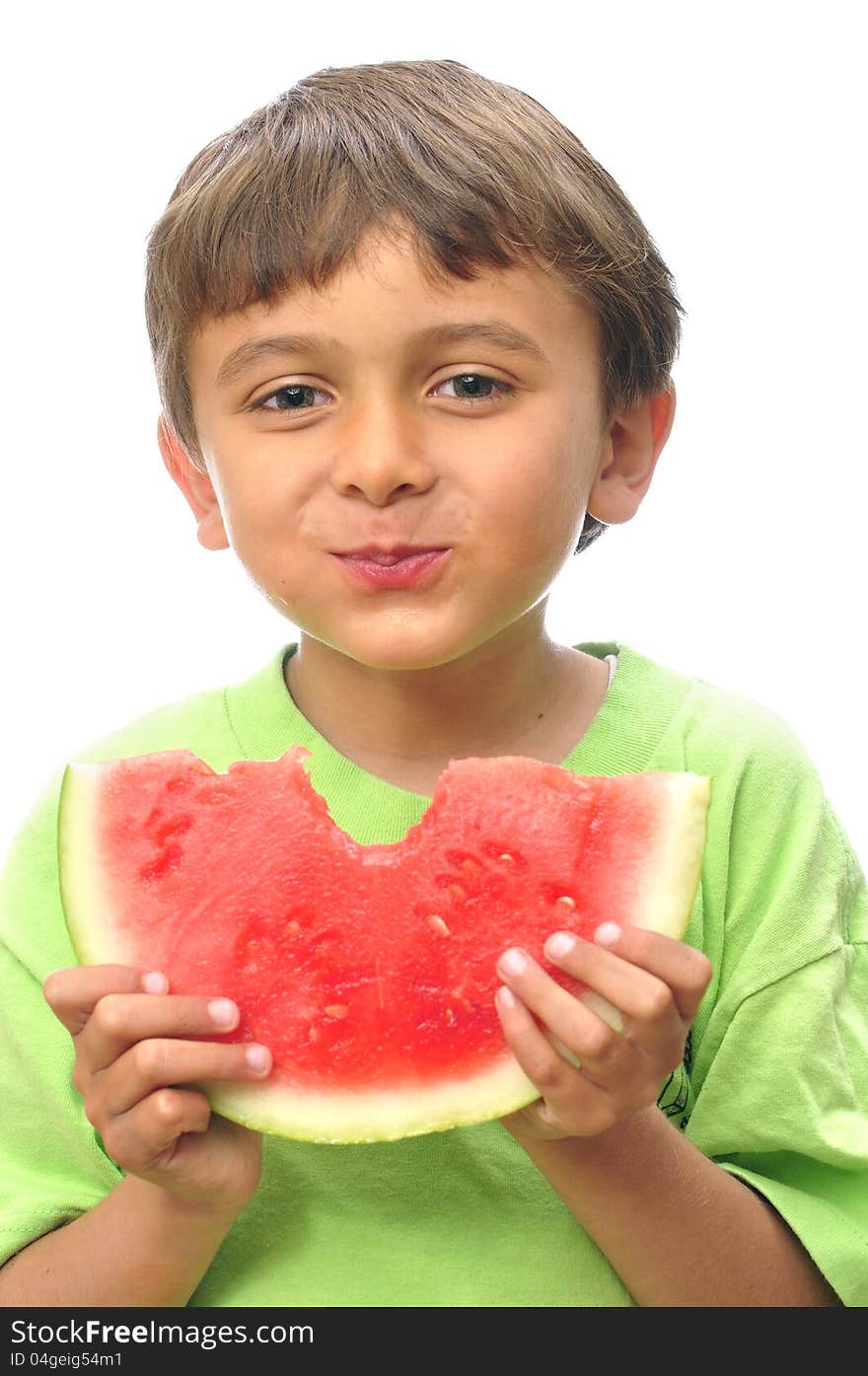 Cute little boy takes a big bite from a slice of watermelon. Cute little boy takes a big bite from a slice of watermelon