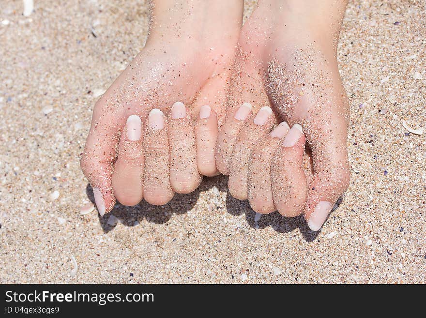 Hands in sand