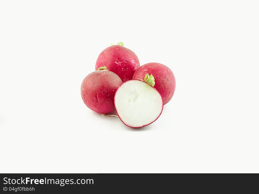 Few radishes and a half on white background