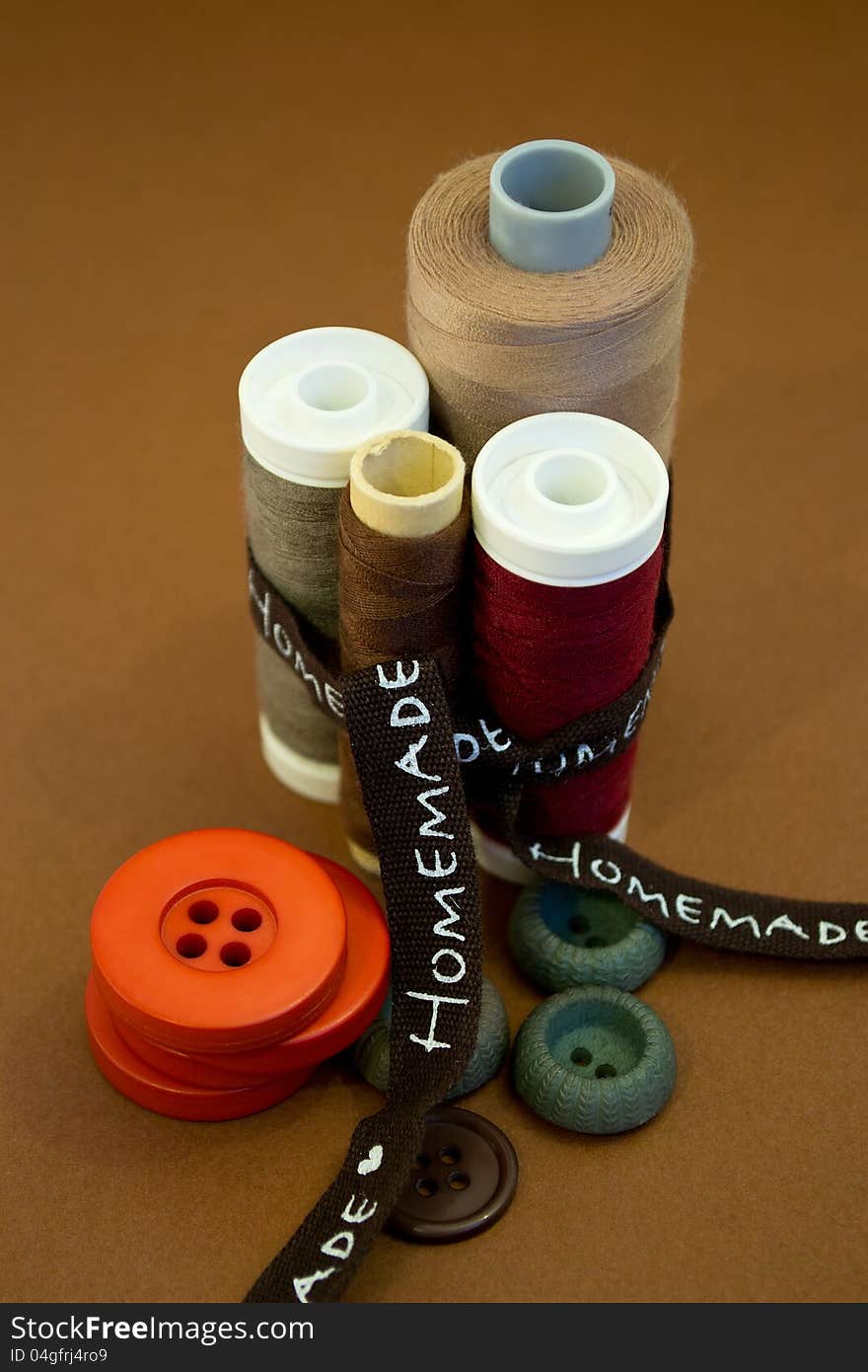 Sewing thread and buttons in various colors and ribbon. Sewing thread and buttons in various colors and ribbon