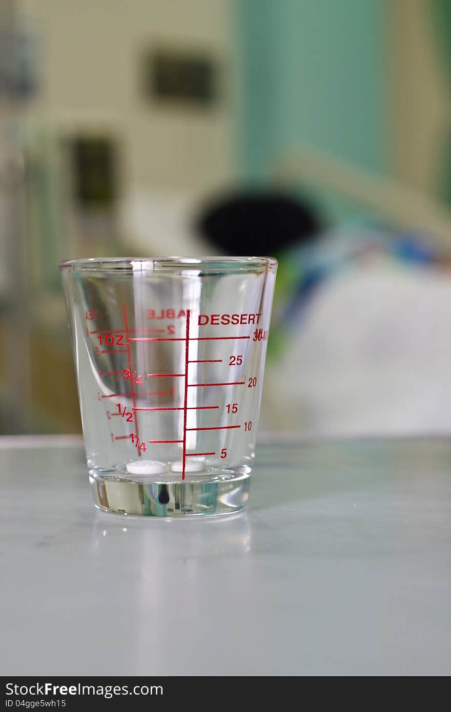 Dosage cup with measurements displayed