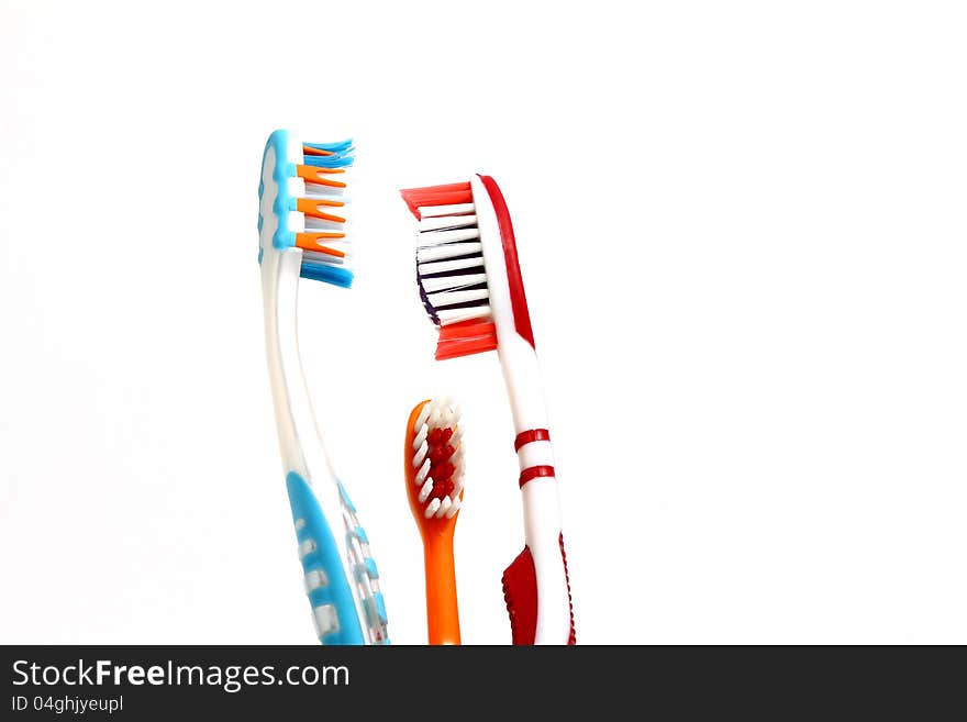 Two adult toothbruses and a kid toothbrush