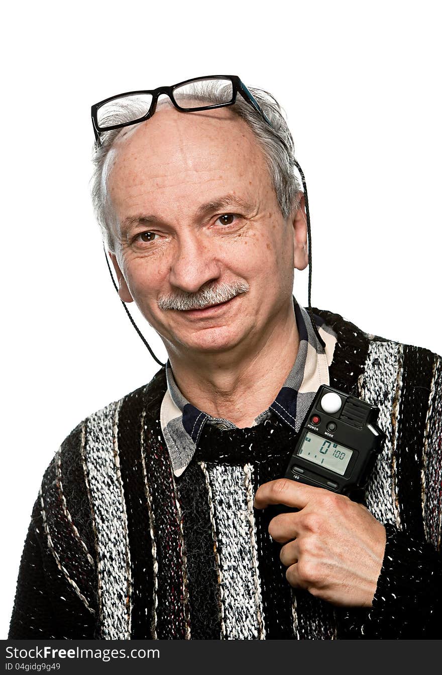 Portrait of a senior photographer with a flash meter and glasses