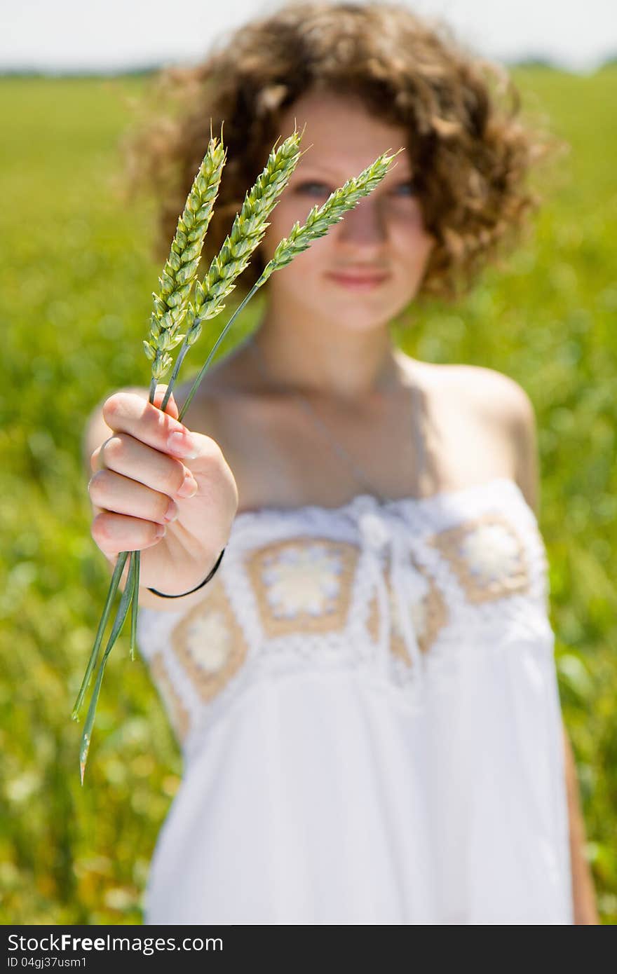 Young Girl Holding A Ear Of Wheat