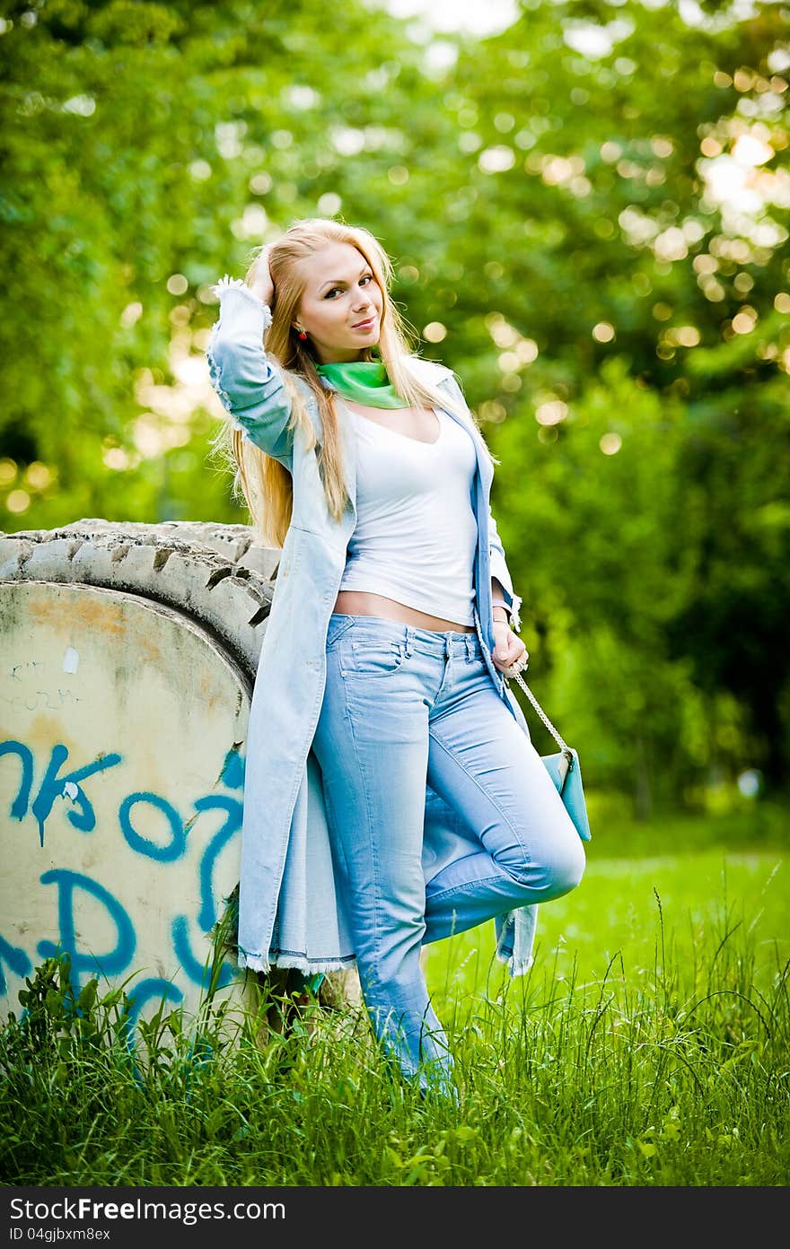 Attractive girl posing in jeans outdoor