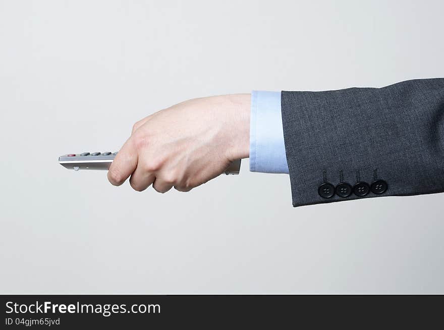 Man in i a suit holding a remote control. Man in i a suit holding a remote control