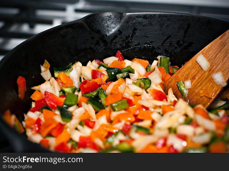 A seasoned arrangement of colorful bell peppers sauteed in a pan. A seasoned arrangement of colorful bell peppers sauteed in a pan.