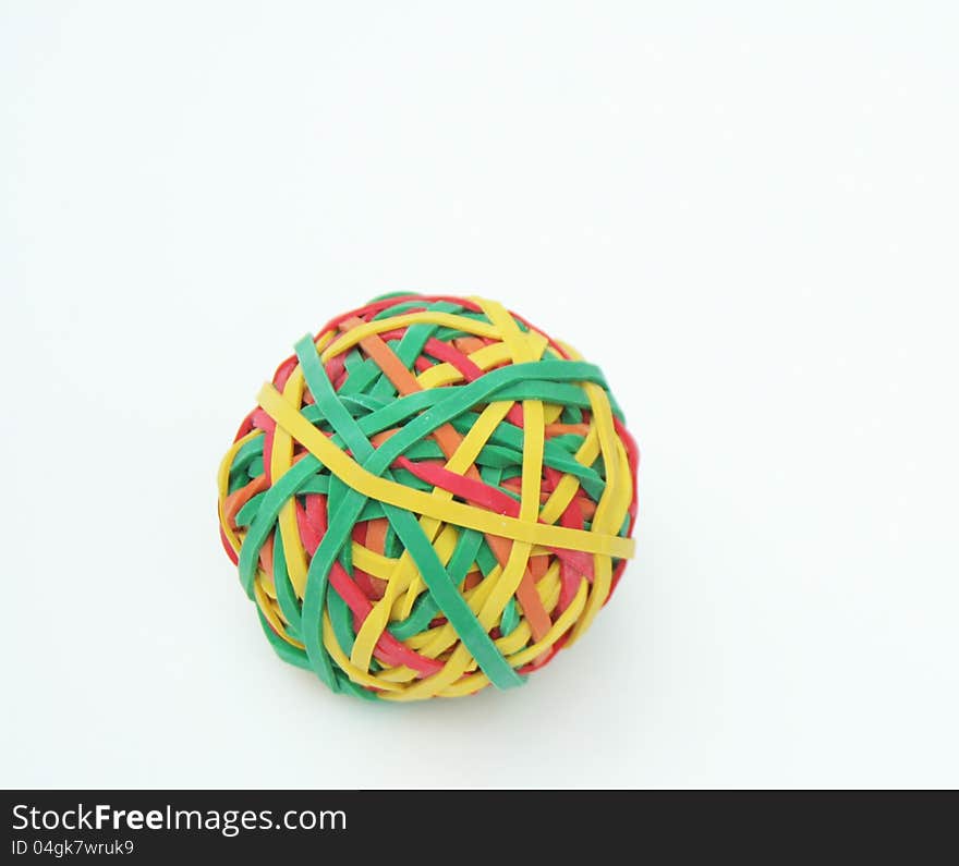 Ball of colored rubberbands on white