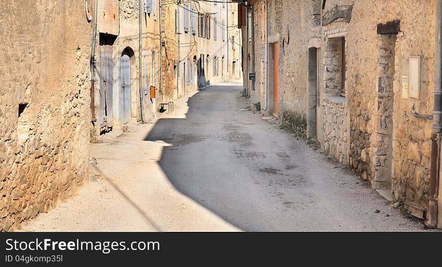 Alleyway in the village along the old stone facade of dwelling. Alleyway in the village along the old stone facade of dwelling