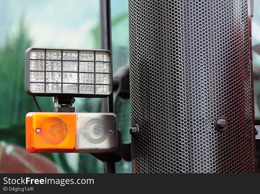 Tractor headlights and a grill covering the exhaust pipe. Tractor headlights and a grill covering the exhaust pipe