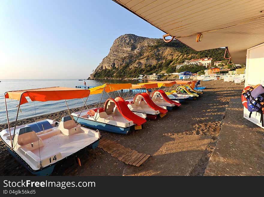 Water bicycles on the black sea coast, before the morning. Ukraine. Crimea. New Light. Water bicycles on the black sea coast, before the morning. Ukraine. Crimea. New Light.