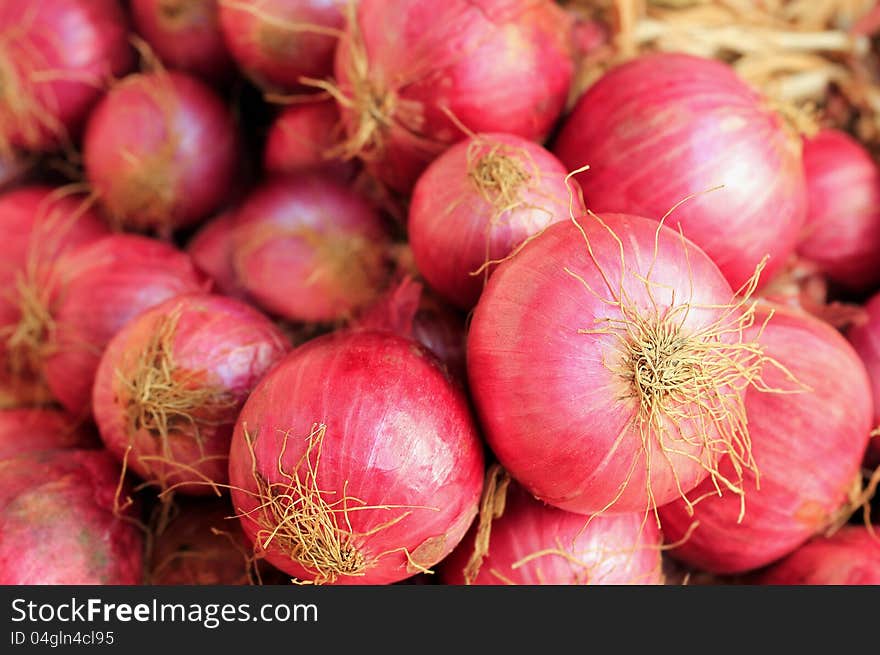 Fresh ripe heap of pink colored salad onions