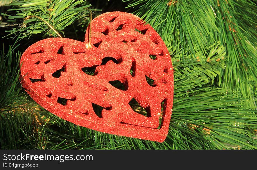 Christmas tree toy in the form of a red heart in close-up