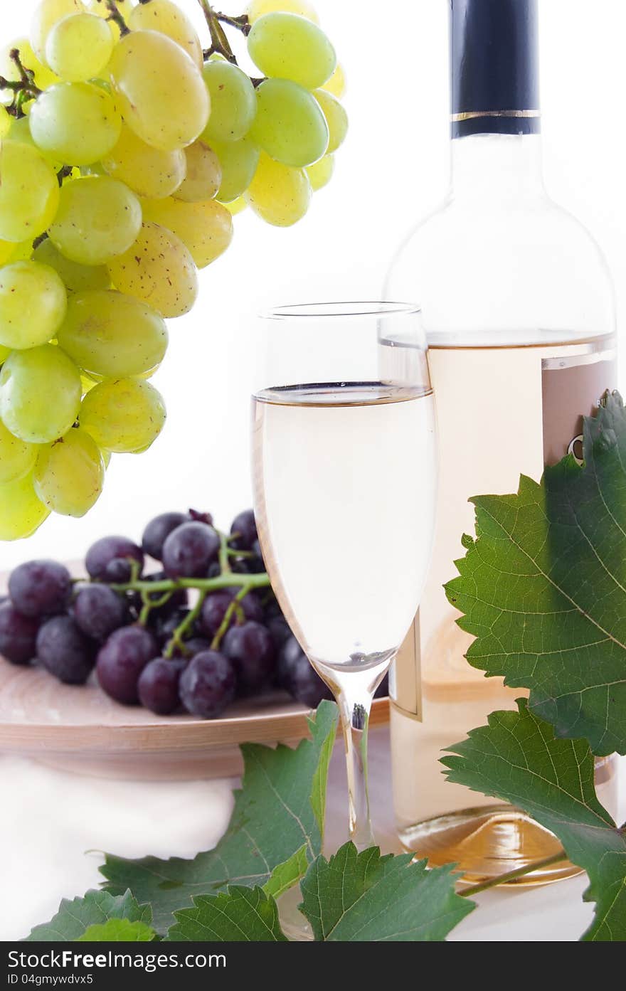 White wine bottle, glass and cask with grapes