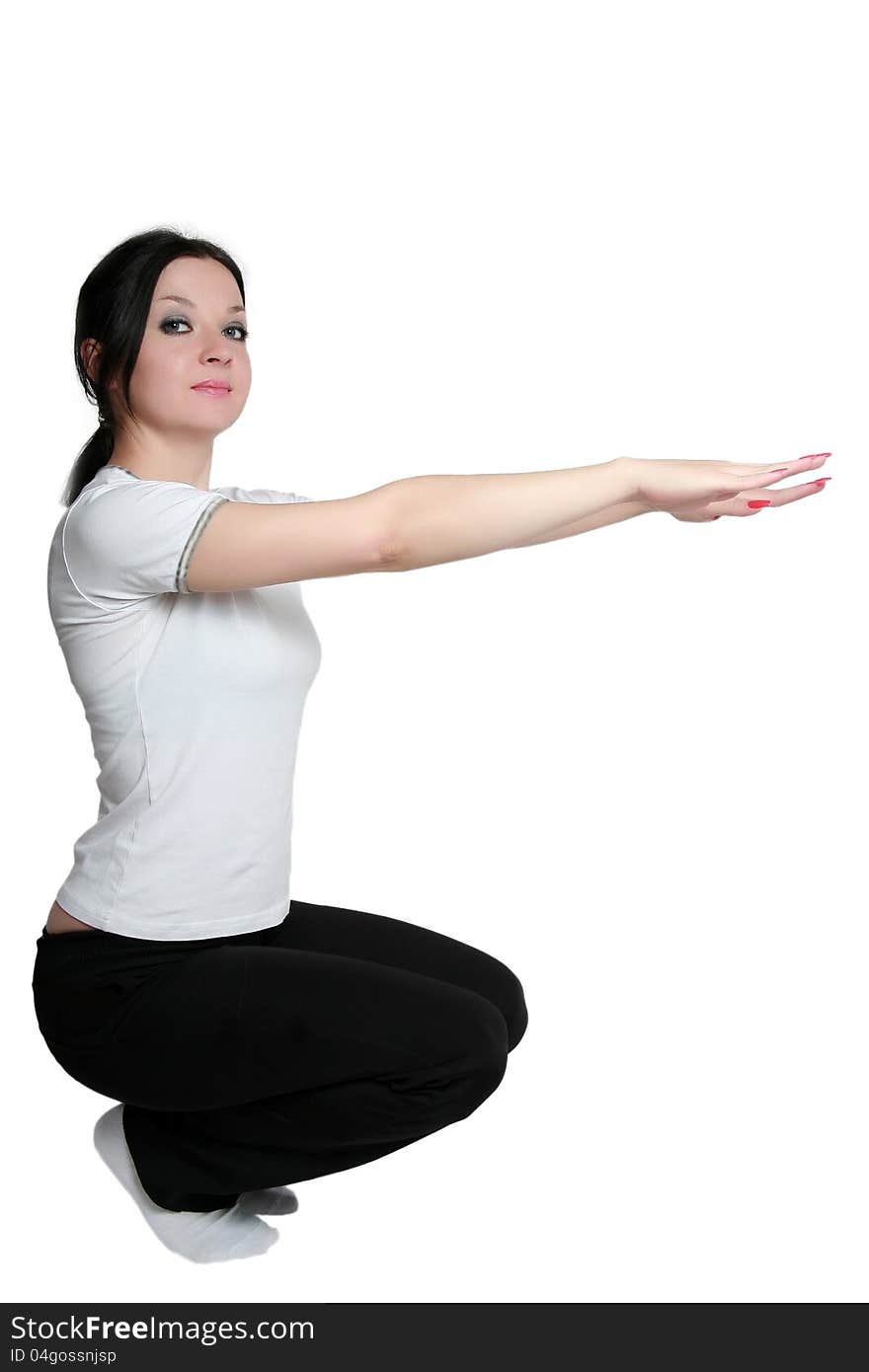 Brunette girl doing exercises on an isolated white background