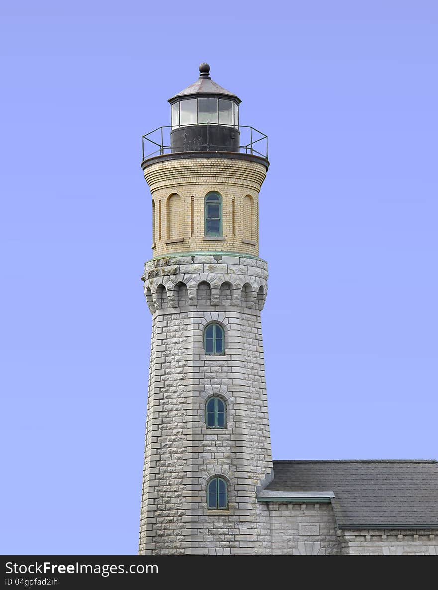 Old stone and brick warning beacon light house.  Isolated against blue. Old stone and brick warning beacon light house.  Isolated against blue.